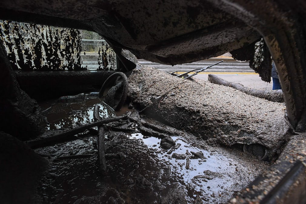   Một chiếc xe bị vùi lấp trong một trận lũ bùn ở Burbank, miền nam California (Mỹ). Ảnh: Robyn Beck / AFP /Getty Images  