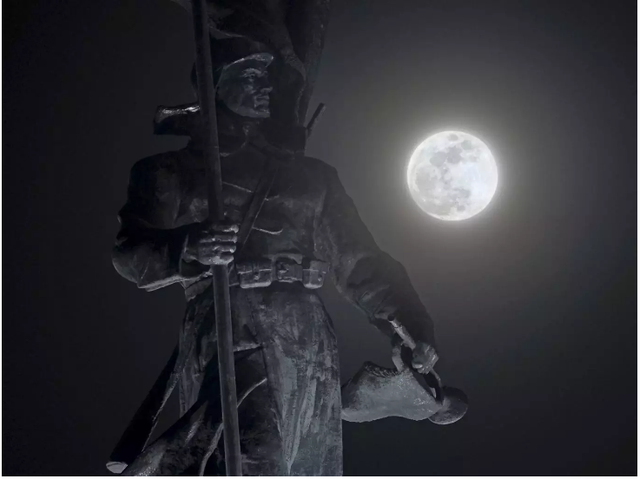 Siêu trăng xuất hiện phía sau tượng đài người chiến sỹ hồng quân Liên Xô tại thành phố Vladivostok, Nga.  Ảnh: AP