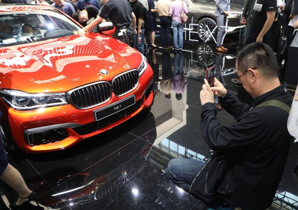 Một người đàn ông chụp ảnh chiếc BMW 'The 7' trong ngày đầu tiê của triển lãm xe hơi Bắc Kinh vào cuối tháng 4 năm 2018. Ảnh: AFP/Getty Images