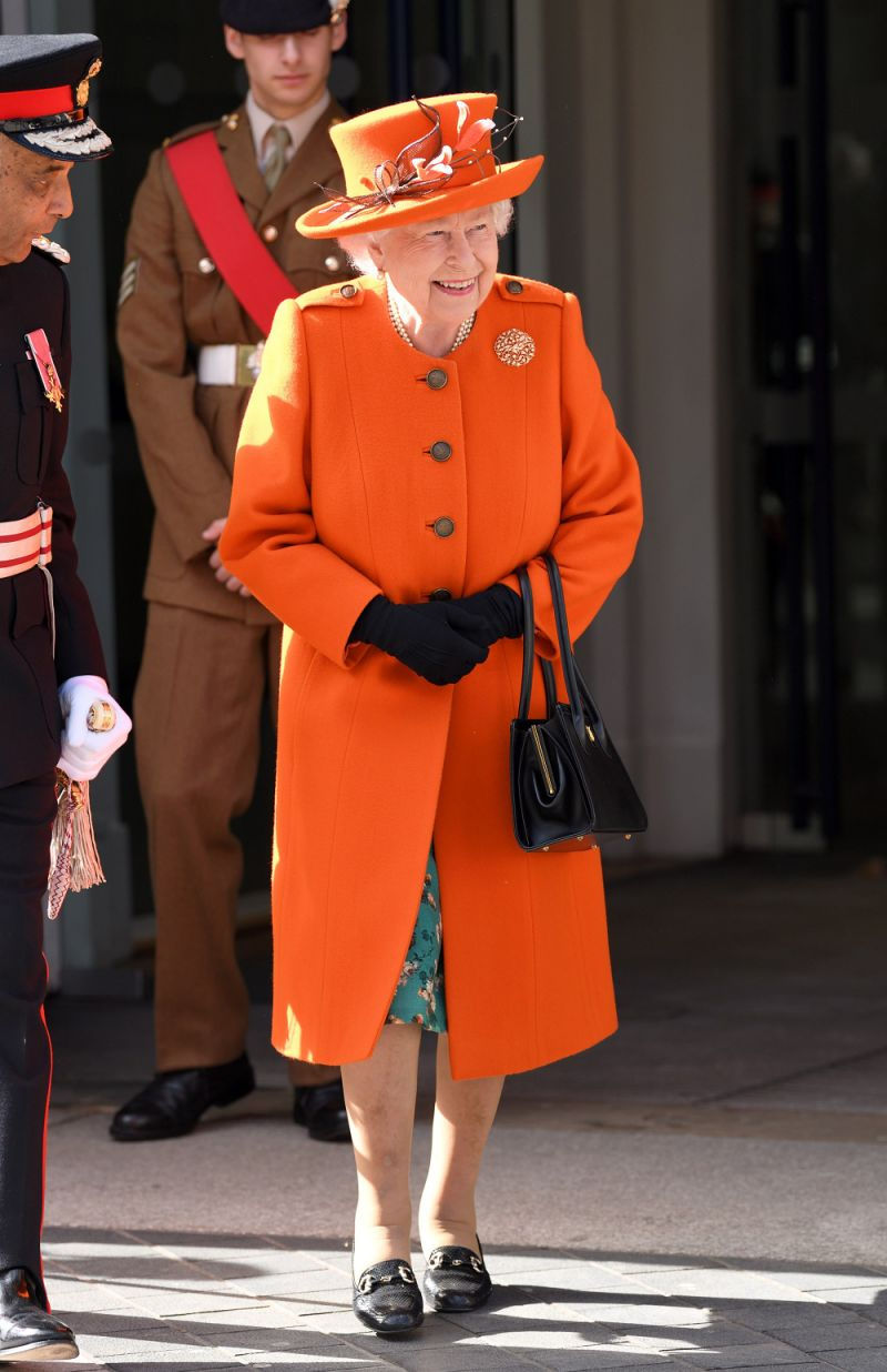 Nữ hoàng Elizabeth II diện váy hoa màu xanh, kết hợp cùng áo khoác và mũ cùng tông màu cam san hô. (Ảnh: flipboard) 