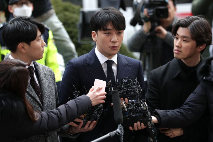 Nghệ sỹ Seungri trả lời phỏng vấn các phóng viên trước khi vào đồn cảnh sát. Ảnh: CNBC.