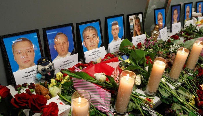 Nến và hoa đặt trước di ảnh của 5 thành viên phi hành đoàn và các nạn nhân khác trong vụ rơi máy bay Ukraine ở Iran, tại Kiev ngày 11/1 - Ảnh: Reuters.