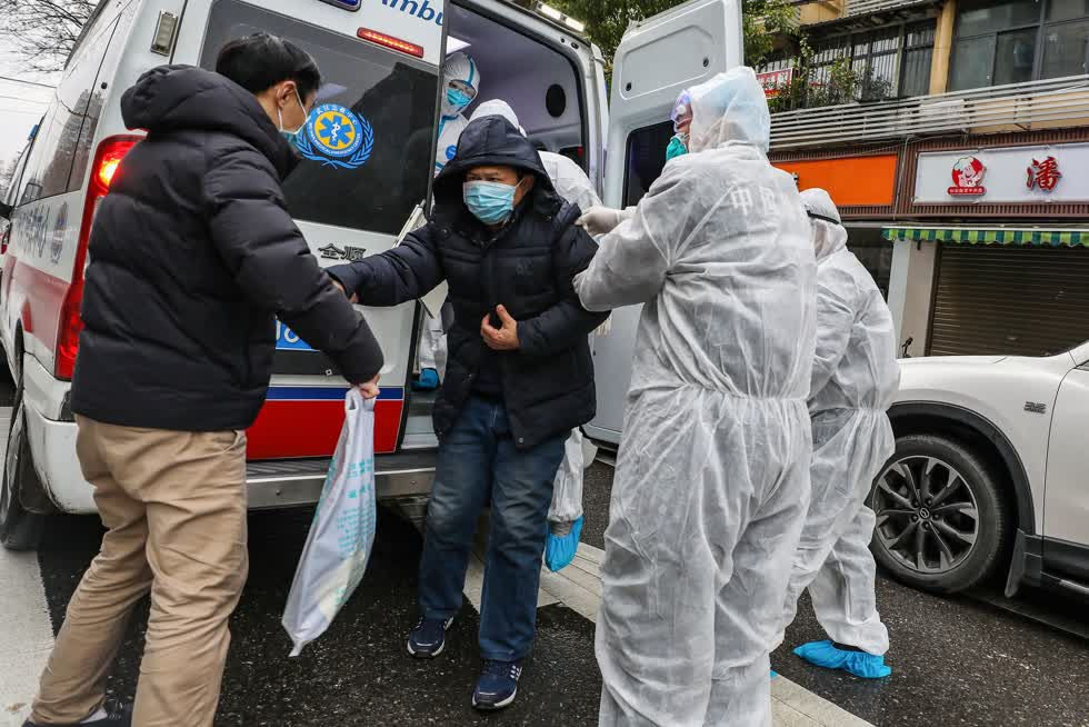 Một bệnh nhân đã được giúp đỡ khỏi xe cứu thương ở Vũ Hán, Trung Quốc, vào Chủ nhật. Ảnh: Getty Images