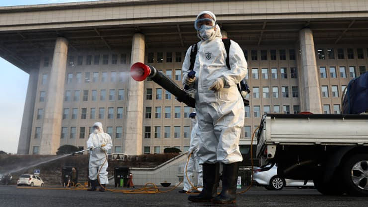  Các chuyên gia khử trùng mặc đồ bảo hộ trong khi phun dung dịch chống lây nhiễm trong các biện pháp kiểm soát virus tại Seoul, Hàn Quốc. 