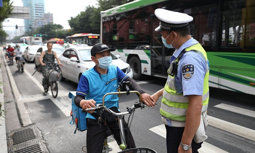     Một cảnh sát tuyên truyền cho người lái xe điện không đội mũ bảo hiểm vào hôm 21/5 tại tỉnh Quảng Đông, Trung Quốc. 