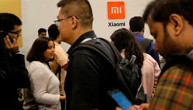     Người tham gia sự kiện ra mắt điện thoại mới của Xiaomi ở Bangalore (Ấn Độ). Ảnh: AP 
