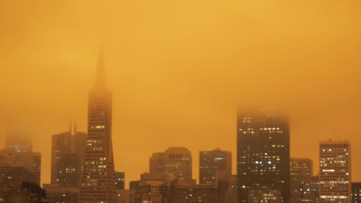   Tòa nhà Transamerica ở San Francisco tối đen bởi khói màu cam bốc cao trong khí quyển, vài giờ sau khi mặt trời mọc vào sáng 9/9. Ảnh: CNBC.  