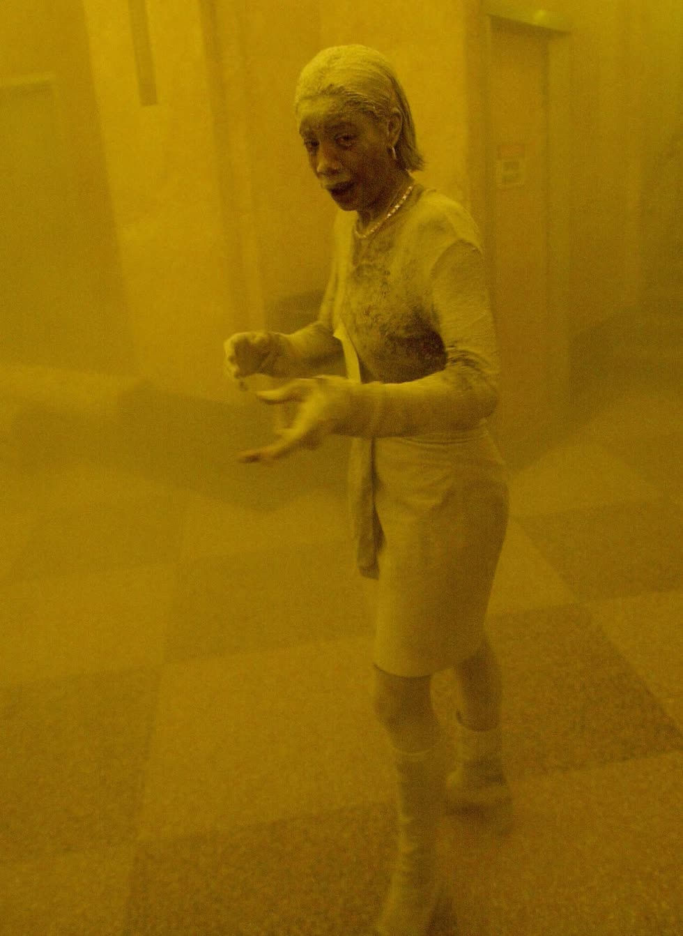 Từ đầu tới chân cô Marcy Borders, một trong những người may mắn thoát khỏi Trung tâm Thương mại Thế giới, bị bụi trắng bao phủ khi tòa nhà sập. Ảnh: Getty Images