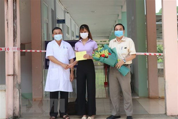Đại diện Bệnh viện Lao và bệnh Phổi tỉnh Đắk Lắk trao Giấy xuất viện cho bệnh nhân 448. Ảnh: Tuấn Anh/TTXVN