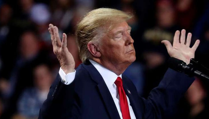 Tổng thống Mỹ Donald Trump trong một cuộc vận động tranh cử ở Michigan hôm 18/12/2019, trong lúc Hạ viện tiến hành bỏ phiếu để luận tội ông. Ảnh: Reuters.