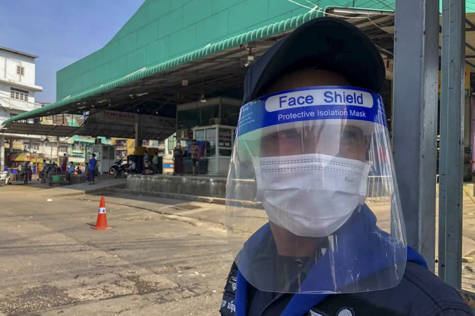 Một nhân viên bảo vệ canh gác tại chợ tôm ở Samut Sakhon hôm 20/12. Ảnh: AP.